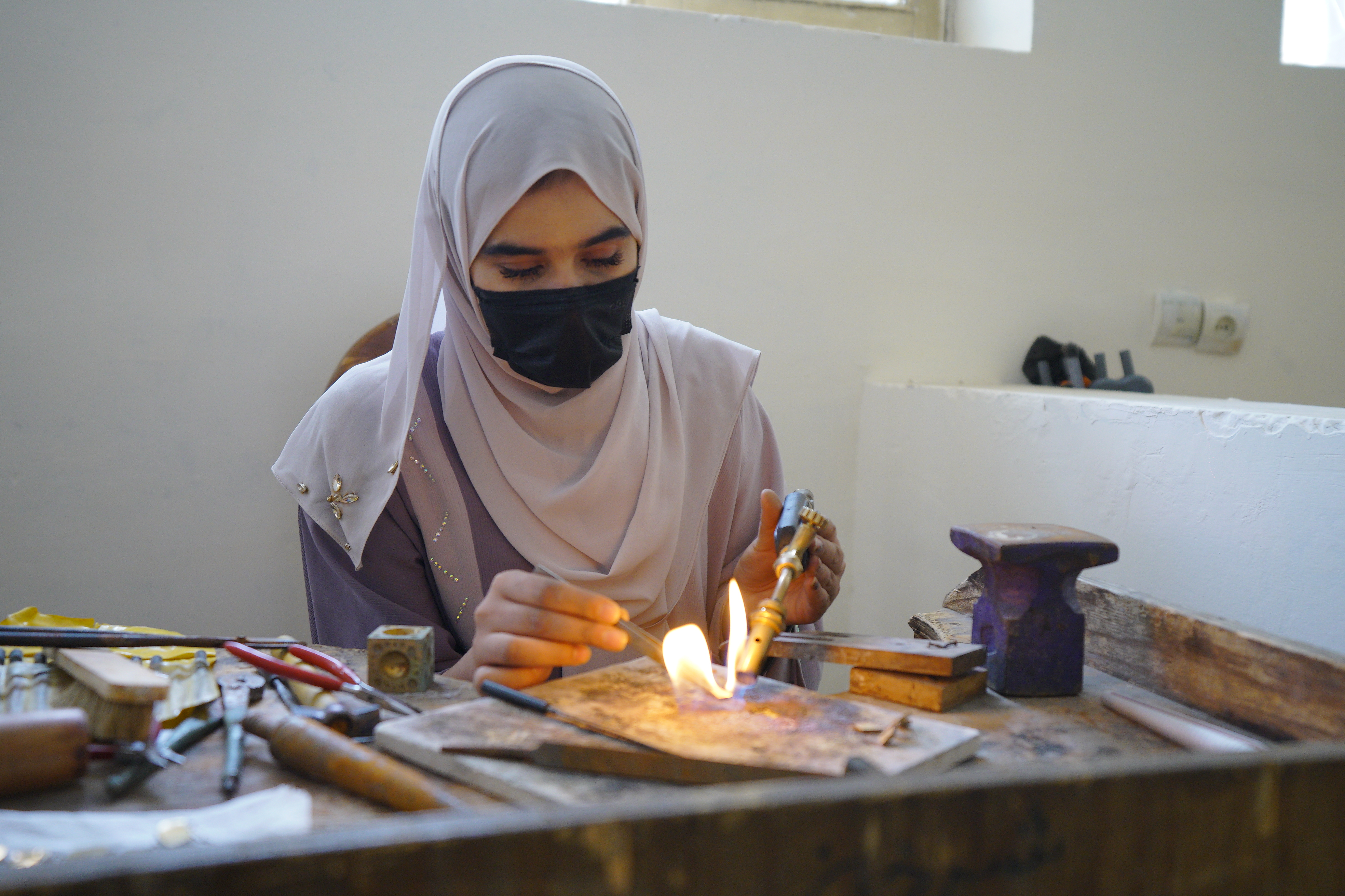 An Afghan artisan at her bench